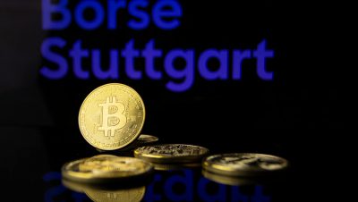 Image of Bitcoin coins with Börse Stuttgart sign, representing cryptocurrency trading.