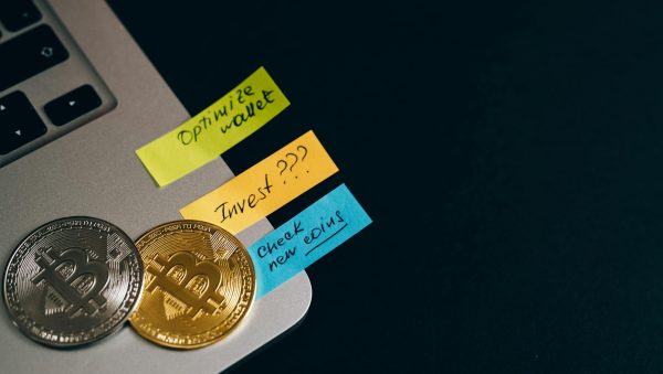 Capture the essence of cryptocurrency investments with Bitcoin coins and sticky note reminders.